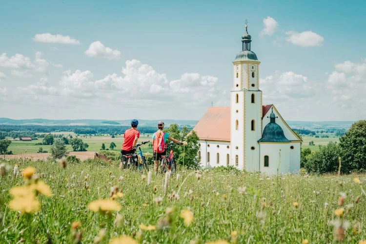 Die 5 beliebtesten Radwege im Altmühltal 4 Radfahrer vor Kirche im Altmühltal